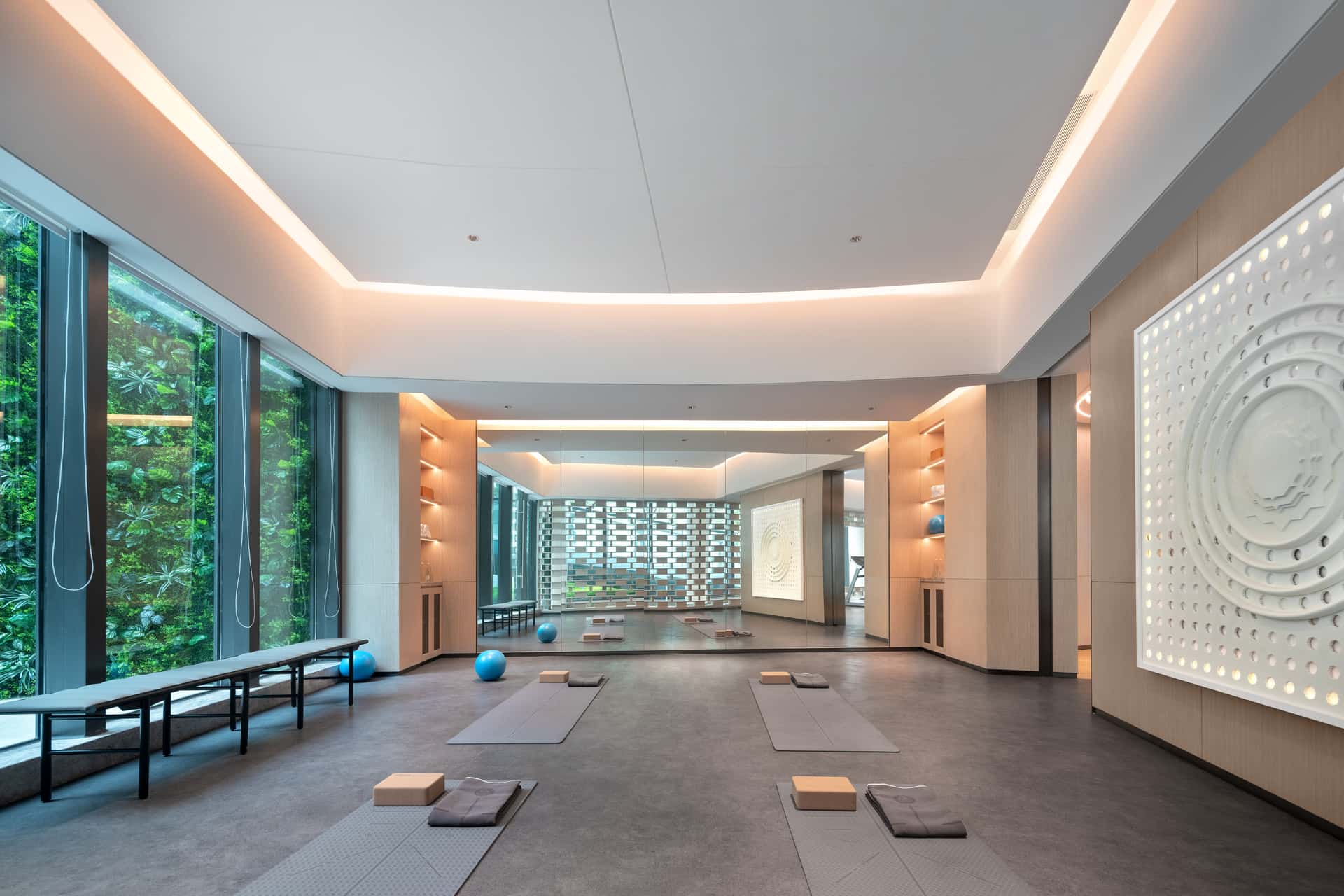 A spacious, empty studio filled with daylight from tall windows